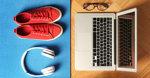 work life balance concept image of shoes and headphones on left and laptop on the right