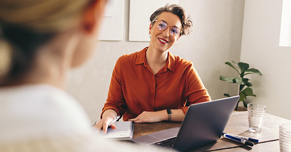 happy manager using metrics to measure employee engagement