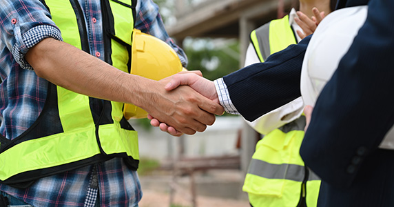 contractor shaking hands with business partner