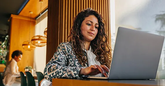 Employee working on laptop in modern office using recognition software