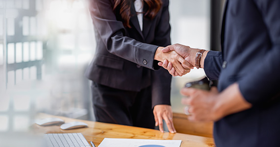 business partners shaking hands after corporate merger