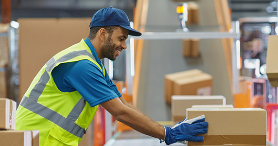 Deskless worker moving packages along conveyor belt
