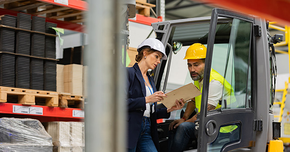 warehouse employee discussing workplace safety with manager