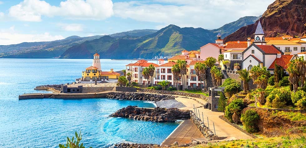 seaside buildings and lighthouse in lisbon portugal