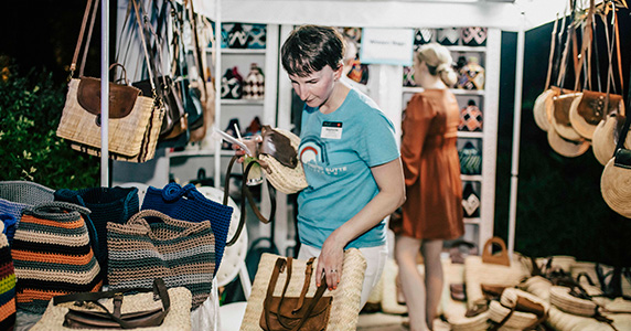 incentive travel event attendee picking out a gift at sponsored market