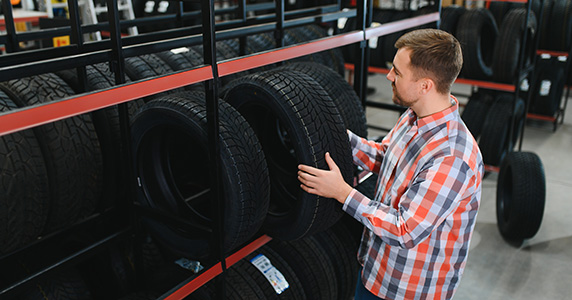 dealership employee selecting tire brand