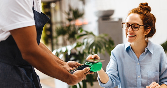 Loyal customer making first purchase at cafe